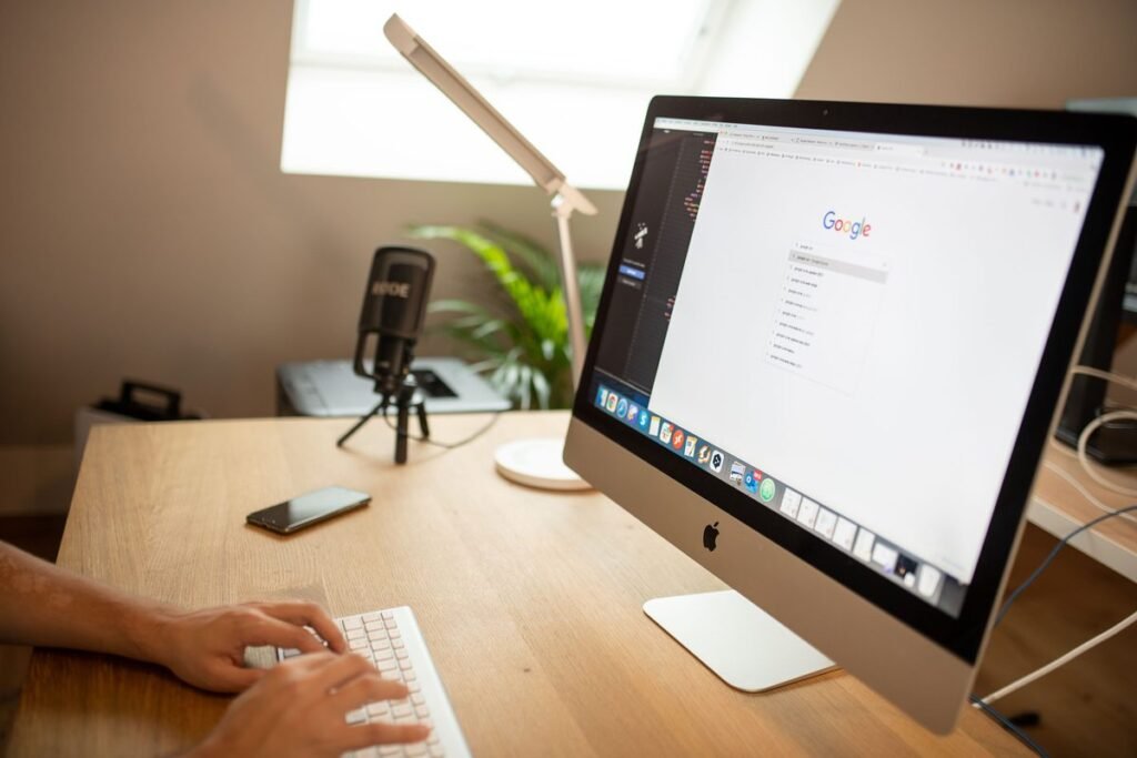 Person working on a computer with Google open, representing online business presence and SEO